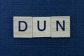 Text from the short word dun from gray wooden letters