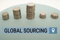 Hand writing sign Global Sourcing. Business idea practice of sourcing from the global market for goods Coins Pile Over