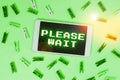 Hand writing sign Please Wait. Business concept to pause any implemented action immediately and hold on Royalty Free Stock Photo