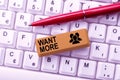 Writing displaying text Want More. Concept meaning Not having enough of something bigger challenges requirements Typing Royalty Free Stock Photo