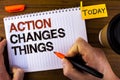 Text sign showing Action Changes Things. Conceptual photo doing something is like chain Improve Reflects written by Man on Notepad Royalty Free Stock Photo