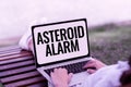 Writing displaying text Asteroid Alarm. Concept meaning warning to prepare the cities in a space rock s is flight path