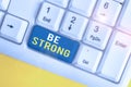 Text sign showing Be Strong. Conceptual photo able to withstand great circumstances or pressure in life White pc