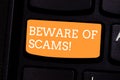 Text sign showing Beware Of Scams. Conceptual photo Stay alert to avoid fraud caution be always safe security Keyboard Royalty Free Stock Photo
