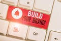 Text sign showing Build Your Brand. Conceptual photo creates or improves customers knowledge and opinions of product White pc Royalty Free Stock Photo