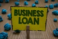 Text sign showing Business Loan. Conceptual photo Credit Mortgage Financial Assistance Cash Advances Debt Clothespin holding yello