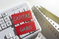 Text sign showing Capital Gains. Word for Bonds Shares Stocks Profit Income Tax Investment Funds Ripped Note With