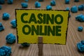 Text sign showing Casino Online. Conceptual photo Computer Poker Game Gamble Royal Bet Lotto High Stakes Clothespin holding yellow