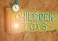 Text sign showing Children Toys. Conceptual photo An object that children play with to develop their motor skill Alarm clock and Royalty Free Stock Photo