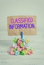 Text sign showing Classified Information. Conceptual photo Sensitive Data Top Secret Unauthorized Disclosure Reminder pile colored