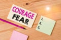 Text sign showing Courage Fear. Conceptual photo quality of mind that enables a demonstrating to face difficulty Colored