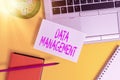 Text sign showing Data Management. Conceptual photo The practice of organizing and maintaining data processes Laptop pencil sheet