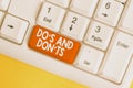 Text sign showing Do S And Don tS. Conceptual photo Rules or customs concerning some activity or actions White pc keyboard with Royalty Free Stock Photo