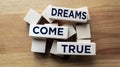 Text sign showing Dreams Come True on wooden blocks. Motivation inspirational quotes for successful people