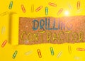 Text sign showing Drilling Contractor. Conceptual photo contract their services mainly for drilling wells Paper clip and
