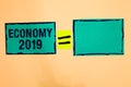 Text sign showing Economy 2019. Conceptual photo State of wealth and resources of a country in upcoming year Turquoise paper notes