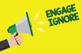 Text sign showing Engage Ignore. Conceptual photo Silent Treatment Manipulative Punishment Sulking Shunning Man holding megaphone Royalty Free Stock Photo