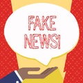 Text sign showing Fake News. Conceptual photo false stories that appear to spread on internet using other media Palm Up Royalty Free Stock Photo