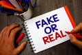 Text sign showing Fake Or Real. Conceptual photo checking if products are original or not checking quality Penholder notepad marke Royalty Free Stock Photo