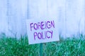 Text sign showing Foreign Policy. Conceptual photo a government strategy in dealing with other nations Plain empty paper attached