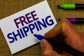 Text sign showing Free Shipping. Conceptual photo Freight Cargo Consignment Lading Payload Dispatch Cartage Man hand holding marke