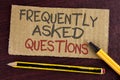 Text sign showing Frequently Asked Questions. Conceptual photo most common inquiries Informations Help Guide written on Cardboard