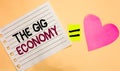 Text sign showing The Gig Economy. Conceptual photo Market of Short-term contracts freelance work temporary Transverse white paper Royalty Free Stock Photo