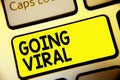 Text sign showing Going Viral. Conceptual photo image video or link that spreads rapidly through population Keyboard yellow key In