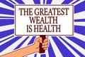 Text sign showing The Greatest Wealth Is Health. Conceptual photo being in good health is the prize Take care Man hand holding pos Royalty Free Stock Photo