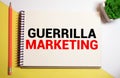 Text sign showing guerilla marketing. The text is written on a small wooden blackboard