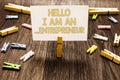 Text sign showing Hello I Am An ...Entrepreneur. Conceptual photo person who sets up a business or startups Clothespin holding whi