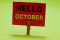 Text sign showing Hello October. Conceptual photo Last Quarter Tenth Month 30days Season Greeting Clothespin holding red