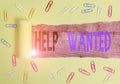 Text sign showing Help Wanted. Conceptual photo An ad in the paper an employer places to find a new employee Paper clip Royalty Free Stock Photo