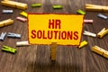Text sign showing Hr Solutions. Conceptual photo Outsourced Human resources consultancy and support Experts Clothespin holding yel