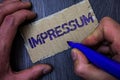 Text sign showing Impressum. Conceptual photo Impressed Engraved Imprint German statement ownership authorship Man working holding