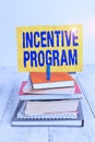 Text sign showing Incentive Program. Conceptual photo specific scheme used to promote certain action or behavior pile stacked