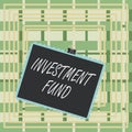 Text sign showing Investment Fund. Conceptual photo A supply of capital belonging to numerous investors Stamp stuck binder clip