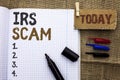 Text sign showing Irs Scam. Conceptual photo Warning Scam Fraud Tax Pishing Spam Money Revenue Alert Scheme written on Notebook Bo Royalty Free Stock Photo