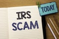 Text sign showing Irs Scam. Conceptual photo Warning Scam Fraud Tax Pishing Spam Money Revenue Alert Scheme written on Notebook Bo Royalty Free Stock Photo