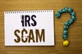 Text sign showing Irs Scam. Conceptual photo Warning Scam Fraud Tax Pishing Spam Money Revenue Alert Scheme written on Notebook Bo Royalty Free Stock Photo