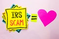 Text sign showing Irs Scam. Conceptual photo Warning Scam Fraud Tax Pishing Spam Money Revenue Alert Scheme written on Stacked Sti Royalty Free Stock Photo