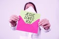 Text sign showing Jesus Loves You. Business overview Believe in the Lord To have faith religious person Woman Holding Royalty Free Stock Photo