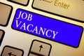 Text sign showing Job Vacancy. Conceptual photo empty or available paid place in small or big company Keyboard blue key Intention Royalty Free Stock Photo