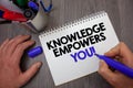 Text sign showing Knowledge Empowers You Call. Conceptual photo Education responsible to achieve your success Man hold holding blu Royalty Free Stock Photo