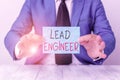 Text sign showing Lead Engineer. Conceptual photo control his team and manage phases of the project in hand Man holds empty paper