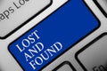 Text sign showing Lost And Found. Conceptual photo Place where you can find forgotten things Search service Keyboard blue key Inte Royalty Free Stock Photo