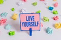 Text sign showing Love Yourself. Conceptual photo have selfrespect and the unconditional selfacceptance Colored crumpled papers