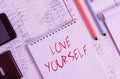 Text sign showing Love Yourself. Conceptual photo have selfrespect and the unconditional selfacceptance Smartphone man wallet