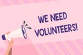 Text sign showing We Need Volunteers. Conceptual photo someone who does work without being paid for it Human Hand Royalty Free Stock Photo