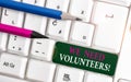 Text sign showing We Need Volunteers. Conceptual photo someone who does work without being paid for it White pc keyboard